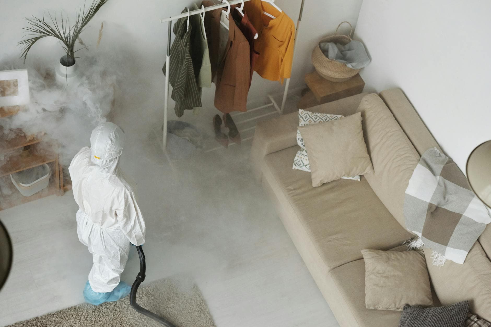 Pest control technician spraying exterior